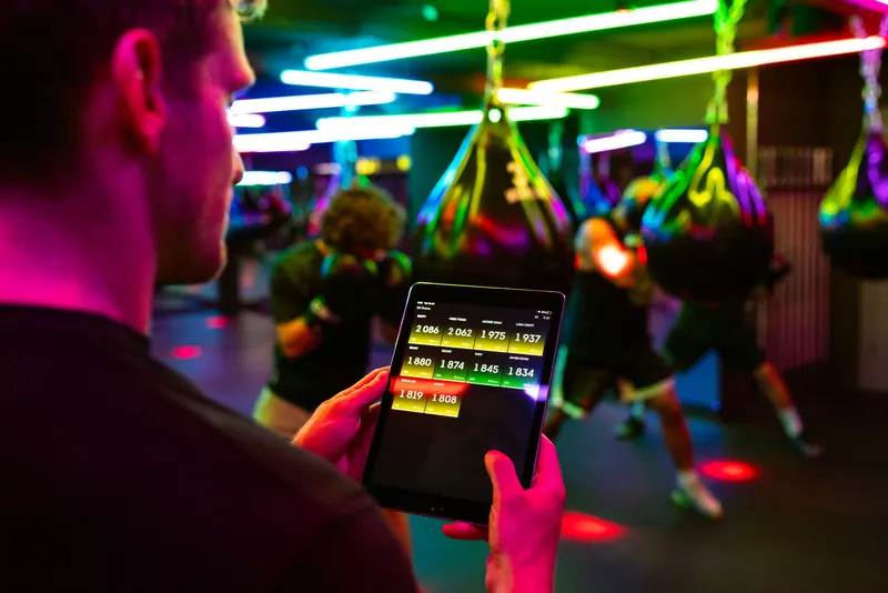 Fitness training in a modern gym with technology for tracking performance on a tablet