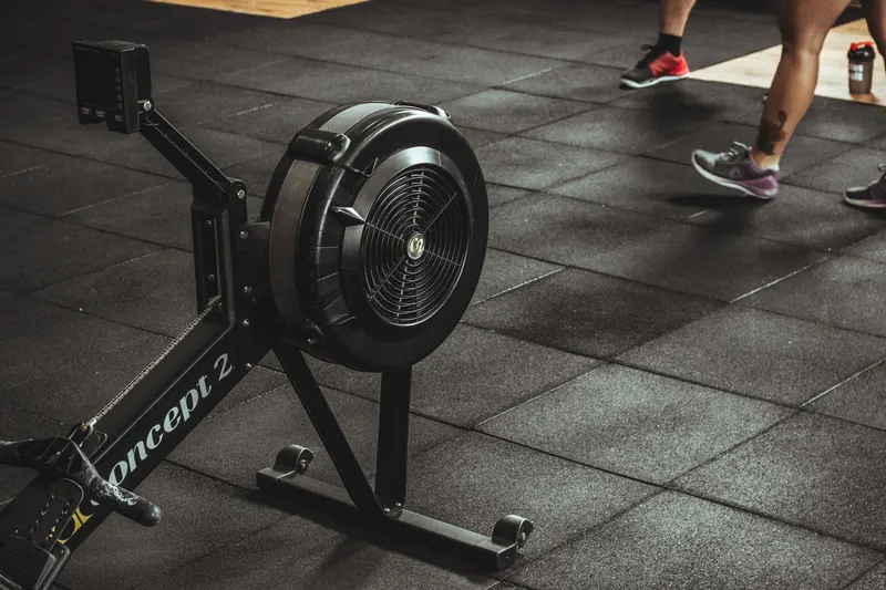 A gym scene featuring fitness equipment and active people exercising indoors